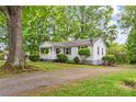 Quaint one-story house featuring a welcoming porch and ample greenery in a serene setting at 93 34Th Street Nw Ct, Hickory, NC 28601