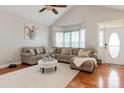 Inviting living room features vaulted ceilings, hardwood floors, a plush sectional couch, and a neutral palette at 9588 Marquette Nw St, Concord, NC 28027