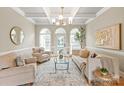 Bright living room featuring coffered ceilings, neutral tones, and large windows for natural light at 1001 Medinah Ct, Waxhaw, NC 28173