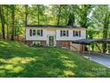 Charming split-level home with red shutters, a brick foundation, and a convenient carport at 1018 Autumn Ln, Hickory, NC 28602