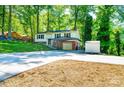 Split-level home featuring a long driveway, carport, storage shed and mature trees at 1018 Autumn Ln, Hickory, NC 28602