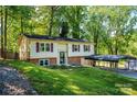 Charming split-level home with red shutters, carport and lovely landscaping at 1018 Autumn Ln, Hickory, NC 28602