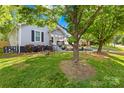 Spacious backyard with lush green grass and mature trees providing ample shade at 1104 Venus St, Kannapolis, NC 28083