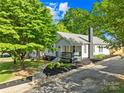 Attractive home with a landscaped yard, welcoming front porch with swing, and mature trees at 1104 Venus St, Kannapolis, NC 28083