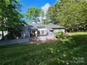 Private backyard featuring a charming patio area and lush greenery at 11216 Carmel Chace Dr, Charlotte, NC 28226