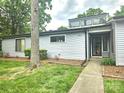 Gray single-story home with a walkway leading to the front door and green lawn at 11216 Carmel Chace Dr, Charlotte, NC 28226