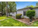 A side view of a charming home with lush landscaping and trees at 11216 Carmel Chace Dr, Charlotte, NC 28226