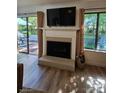 Cozy living room with fireplace, large windows, and access to the backyard at 11216 Carmel Chace Dr, Charlotte, NC 28226