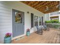 Inviting front porch with rocking chairs, plants and decorative wreath on the front door at 12224 Huntersville Concord Rd, Huntersville, NC 28078