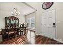 Elegant dining room with hardwood floors, chandelier, and classic furniture, perfect for formal gatherings at 1403 Rosemont Dr, Fort Mill, SC 29707