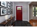 Stylish foyer featuring a red front door and decorative console table at 1427 Worcaster Pl, Charlotte, NC 28211