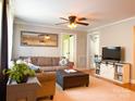 Comfortable living room featuring a cozy seating area and modern entertainment center at 217 Hickory Dr, Mooresville, NC 28115
