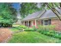 A well-maintained brick home with manicured lawn, featuring a classic design and inviting entrance at 2235 Ramblewood Ln, Charlotte, NC 28210