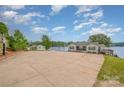 Exterior view of the waterfront home with driveway and lake in the background at 235 River Loop Rd, Belmont, NC 28012