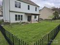 Spacious, fenced backyard features a covered patio and a well-maintained lawn at 248 Aylesbury Ln, Indian Trail, NC 28079
