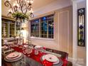 Elegant dining room with city views, chandelier and a beautifully set table. For sale by Canopy MLS 2025 at 301 W 10Th W St, Charlotte, NC 28202
