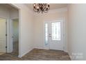 Elegant entryway with wood floors, decorative lighting, and a beautiful front door at 309 Kentmere Ln, Clover, SC 29710