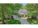 Charming two-story home featuring a three-car garage, well-manicured lawn, and lush landscaping at 3508 Mountain Cove Dr, Charlotte, NC 28216
