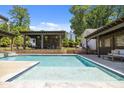 Inviting backyard pool with tanning ledge, pergola, and outdoor seating area at 4147 Chelmsford Rd, Charlotte, NC 28211