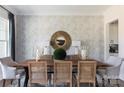 Elegant dining room featuring stylish wallpaper, striking mirror, and seating for six at 503 Meadow Ridge Dr, Belmont, NC 28012