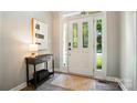 Bright foyer featuring a white front door with decorative glass and a stylish console table at 7722 Garnkirk Dr, Huntersville, NC 28078