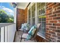 Cozy front porch with comfortable seating and brick detailing at 7722 Garnkirk Dr, Huntersville, NC 28078