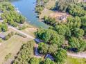 Aerial view of property showcasing lake access, lush landscaping, a neighboring field and charming homes along the shoreline at 7733 Skyline Dr, Sherrills Ford, NC 28673