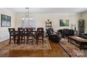 Elegant dining room featuring hardwood floors, crown molding, and a stylish chandelier at 8128 Sealey Ct, Charlotte, NC 28277