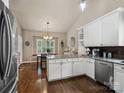 Bright eat-in kitchen with white cabinetry, granite countertops, and stainless steel appliances at 8128 Sealey Ct, Charlotte, NC 28277