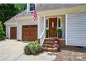 Inviting front entrance with a stained wood door and brick steps at 8501 Flanagan Ct, Huntersville, NC 28078