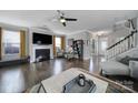 Bright, open living room with hardwood floors, fireplace, and large windows at 8702 Aspinwall Dr, Charlotte, NC 28216