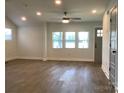 Bright living room featuring recessed lighting, ceiling fan, and large windows allowing natural light at 913 Winchester Ave, Monroe, NC 28110
