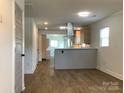 Open-concept living space showcasing stylish flooring, with modern kitchen view at 913 Winchester Ave, Monroe, NC 28110