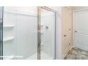 Clean shower features clear glass doors and built-in shelving at 1033 20Th Avenue Se Loop, Hickory, NC 28602