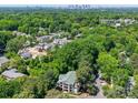 Stunning aerial view showcasing a neighborhood with lush greenery and a distant skyline at 1052 Churchill Downs Ct # I, Charlotte, NC 28211