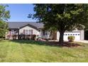 Charming single-story home featuring a well-manicured lawn and mature trees at 109 Hunter Ct, Oakboro, NC 28129