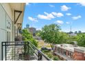 Relaxing balcony view overlooking lush greenery, city buildings, and a bright, sunny sky at 1101 W 1St St # 408, Charlotte, NC 28202