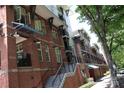 Brick apartment building complex featuring balconies and awnings with a staircase leading up to the units at 1101 W 1St St # 408, Charlotte, NC 28202