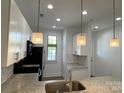 Bright kitchen showcasing granite countertops, stylish pendant lighting, and stainless steel appliances at 1101 W 1St St, Charlotte, NC 28202