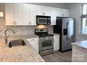Well-lit kitchen featuring granite countertops, stainless steel appliances, and modern cabinetry at 1101 W 1St St # 408, Charlotte, NC 28202