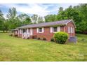 Lovely brick home with a lush, green lawn, complemented by neatly trimmed bushes and a tranquil ambiance at 115 Patterson Rd, Kings Mountain, NC 28086