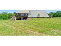 Spacious backyard with metal-roof home and covered area below, perfect for storing lawn and garden equipment at 1307 Tiffany Ln, Shelby, NC 28152