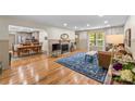 Open-concept living room with hardwood floors, a cozy fireplace, and a seamless transition to the dining area at 1338 Pell Dr, Lincolnton, NC 28092