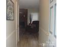View down the hallway featuring hardwood floors, fresh paint, and an inviting entryway at 146 Barclay Ln, Mooresville, NC 28115