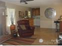 Living room showcasing fireplace, breakfast bar with seating, and open access to the kitchen at 146 Barclay Ln, Mooresville, NC 28115