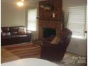 The living room features hardwood floors, fresh paint, brick fireplace and a mounted fish at 146 Barclay Ln, Mooresville, NC 28115