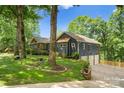 Charming blue home with a two-car garage and well-maintained lawn, nestled among mature trees at 146 Paradise Peninsula Rd, Mooresville, NC 28117