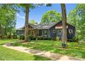 Blue home with stone facade, covered porch and landscaped yard at 146 Paradise Peninsula Rd, Mooresville, NC 28117