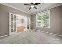 Comfortable office space with carpet, French doors, and a large window for natural light at 14625 Lyon Hill Ln, Huntersville, NC 28078