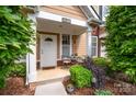 Charming townhome entrance with outdoor seating, plants, and a well-maintained front door at 15318 Coventry Court Ln, Charlotte, NC 28277
